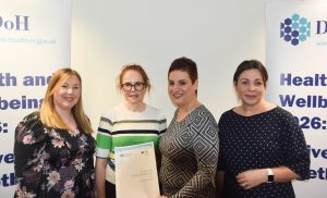 Event speakers pictured with the report